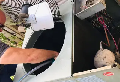 Rheem pro technician running maintenance on older unit