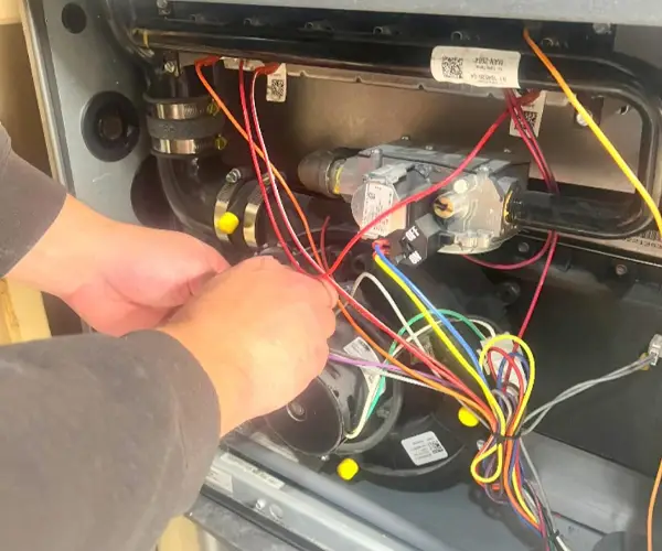 Technician wiring a new furnace